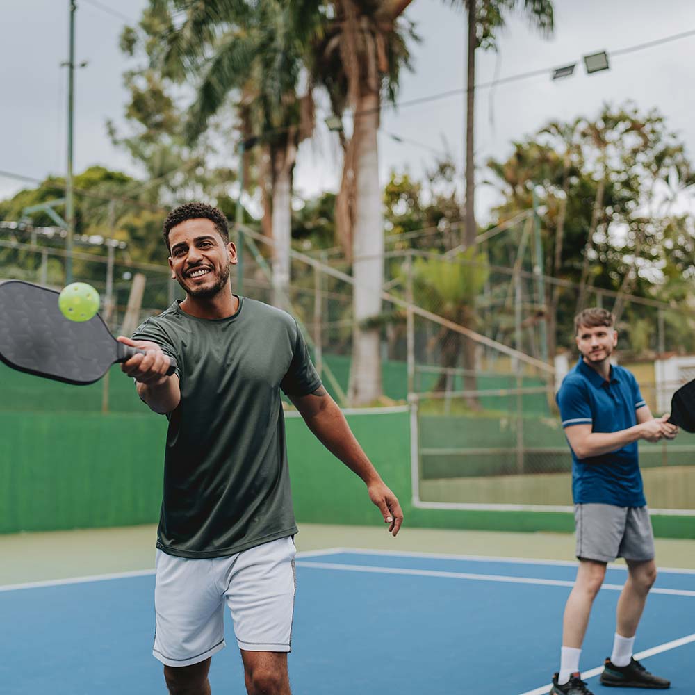 two men play pickleball