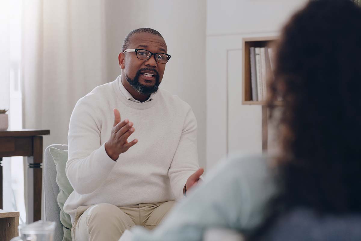 a psychologist speaks with his patient