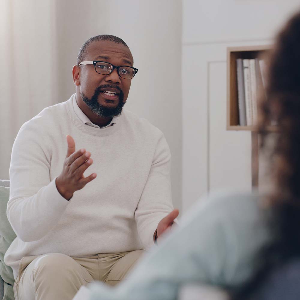 a psychologist speaks with his patient