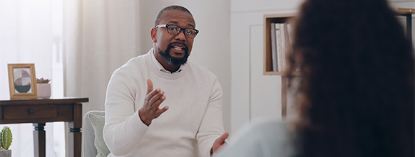 a psychologist speaks with his patient
